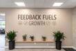© Mizanur - Motivational wall art with feedback fuels growth text and decorative icons in a modern office interior