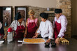 © Jordi Mora - Chef teaching students how to prepare food in cooking class