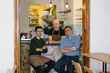 © Carlo Prearo - Three cheerful restaurant owners posing in their newly opened bistro