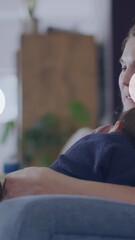 Wall Mural - animation of social media icons over caucasian woman holding baby and using smartphone