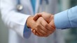 © WS Studio 1985 - Handshake of trust: A close-up shot depicts a warm handshake between a medical professional and a patient, symbolizing trust, care, and a commitment to health.