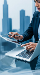 Wall Mural - close-up of hands using tablet and laptop, modern workplace scene, showcasing efficient business tec