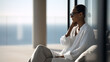 © GrayFrog - Stylish woman in sunglasses and elegant white clothing relaxes on a modern terrace with a beautiful ocean view.