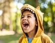 © Reno - A child in a dinosaur costume laughs joyfully outdoors