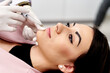 © ADDICTIVE STOCK - Cosmetic procedure with syringe for lip enhancement