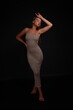 © Сергей Луговский - Slender barefoot young woman in grey dress full length low key portrait
