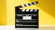 © irawan710 - Black clapperboard on yellow background