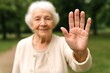 © Jafree - Elderly woman gesturing stop with hand in park. concept of communication, warning, outdoor activity, senior lifestyle, human interaction, nature.