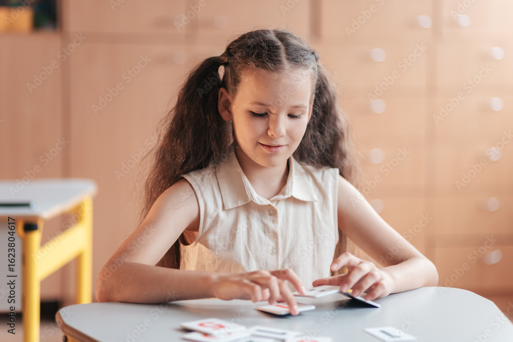 Young Student Engaged in Learning at a School Desk During Her First ...