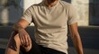 © SAFIICLON - Athletic man wearing a blank beige t-shirt mockup, posing in an urban setting. High-quality apparel template.