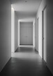 © Sumanto - Serene architectural minimalism: A long, clean hallway with sleek lines and soft light