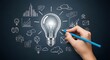 © ESHAL STUDIO - Hand sketching a bright light bulb surrounded by a diverse array of business and tech concept icons on a chalkboard.