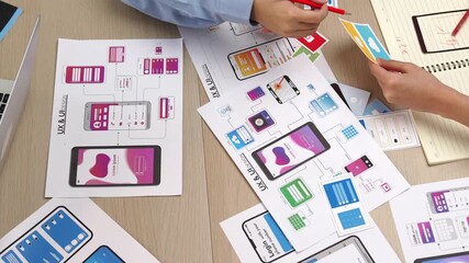 Wall Mural - top view panorama video of startup company employee planning on user interface prototype for mobile 