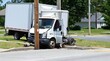 © Abdulloh - Box truck crashing into a telephone pole on a residential street