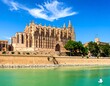 © Elon - Majestic Cathedral Overlooking Turquoise Waters Under a Bright Blue Sky Palma Spain