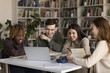 © fizkes - Blended education and peer learning. Multiethnic diverse gen z students pupils use notebook in library watch web based video lesson together prepare group project reviewing online lecture paper books