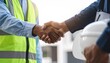 © MdRakibul - Two engineer shaking hands with deals and congratulations on success, panorama
