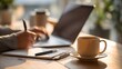 © Nattapol - Person using laptop on a desk with coffee cup and notepad beside