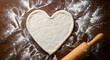 © Inkreatif - Heart shaped pizza dough ready for toppings romantic recipe
