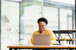© David - Happy African American Businesswoman Using Laptop At Workplace  Modern Office. Copy Space