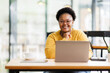 © David - Happy African American Businesswoman Using Laptop At Workplace  Modern Office. Copy Space