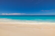 © icemanphotos - Beautiful tranquil sunny beach with soft sand, calm sea, and clear blue sky peaceful Mediterranean coastline perfect for beauty summer vacation, tourism, nature scenery and travel background wallpaper