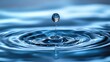 © Jason - A macro close-up of a single water droplet bouncing on a water surface, creating concentric ripples. A concept for purity, the ripple effect, tranquility, and cause and effect.