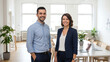 © True Stock - Smiling startup co-founders in bright modern minimalist office