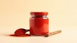 © desain - Red spice powder in a glass jar and wooden spoon.
