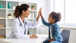 © NafiliaEmil - Smiling female doctor give high five to little biracial patient. Detailed high quality.