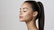 © NN AI - Beautiful woman with closed eyes showing serene expression and natural glowing skin in soft lighting. Asian female displaying peaceful meditation pose with healthy complexion. Wellness beauty concept