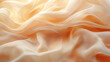© Tenth - Soft, flowing peach-toned fabric draped in gentle folds