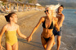 © BGStock72 - Joyful family enjoying a sunny beach day while playing in the sand