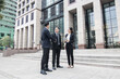 © khwanchai - Business investors in suits stand outside the building discussing investment plans and business expansion plans to achieve their goals