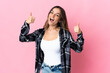 © luismolinero - Young Romanian woman isolated on pink background giving a thumbs up gesture