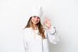 © luismolinero - Young caucasian chef woman isolated on white background showing ok sign with fingers