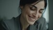© tao - Portrait of a smiling woman in a gray suit, standing against the backdrop of a blurred modern office, exudes confidence and professionalism in a corporate setting.