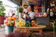 © Pichsakul - Asian woman florist arranges artificial flowers in her vibrant flower shop preparing beautiful unique floral designs and selecting bouquets for modern home decor