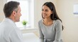 © Mbahjuri - Warm Medical Consultation Doctor in White Coat Advising Smiling Brunette Patient in Heather Gray Top in Bright Clinic Setting