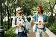 © shurkin_son - Adult men in stylish casual clothes strolling in city under trees, enjoying small talk, colleagues or friends meeting after working day on summer evening to share gossips and current trends and news