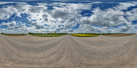 Wall Mural - hdri 360 panorama view on crossroads of gravel country roads among fields with clouds in sky in equi