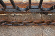 © Nargiza - a rusty old massive chain near the metal grating of the bridge lies on the sidewalk