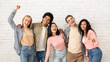 © Prostock-studio - Have fun with friends and get education in college or university. Happy young multiethnic people team in casual hugging and looking at camera, on white brick wall background, studio shot