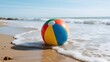 © erina - Colorful Beach Ball on the Sandy Shore with Gentle Waves