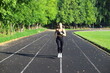 © Anton Belovodchenko - Adult European Woman in Black Running in Open Stadium.