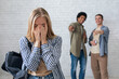 © Prostock-studio - Bullying, negativity and peer problems. European and african american teens zoomers guys laugh at crying female with backpack in school or college, on white wall background, studio shot, empty space