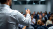 © Ada - Lecture and training in business office for white collar colleagues. Focus on hands of speaker. professional male presenter in a white shirt, holding a blue marker in his hand
