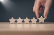 © Prosenjit - Elevating Excellence: A hand delicately places the final star, completing the perfect rating, symbolizing exceptional customer satisfaction and service quality.