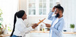 © Prostock-studio - Joyful black couple having fun in kitchen, playfully fighting with kitchenware, aiming each other with utensils tools and laughing, young african spouses having enjoying time at home, copy space