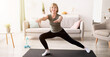 © Prostock-studio - Happy senior lady doing lunges on domestic workout in living room, copy space. Sporty mature woman leading healthy lifestyle, keeping fit or losing weight at home during covid quarantine